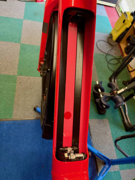 Plastic cable guides inside the e-bike battery bay.