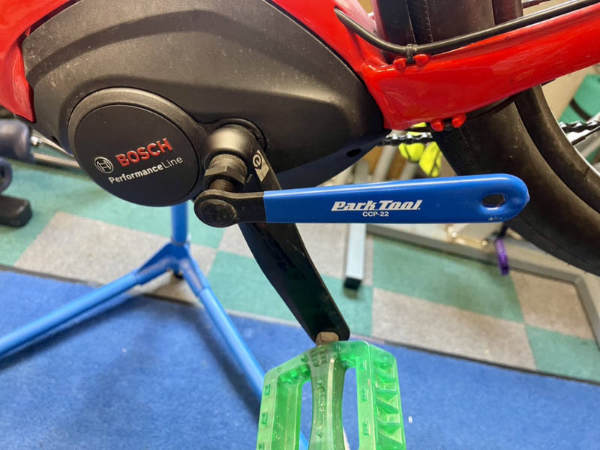 Using a crank puller tool to remove the crank arm.